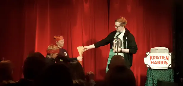 Volunteers help out making some props Kristien Harris devon magician on stage at the Barbican BBar stage for Wednesday night magic